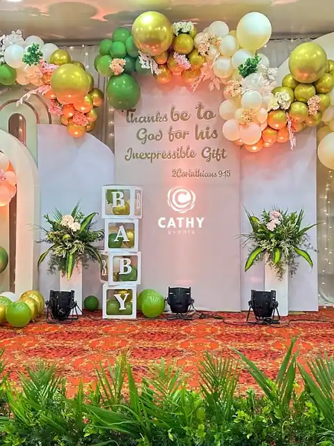 Baby shower stage with pastel balloon garlands, arches and baby blocks