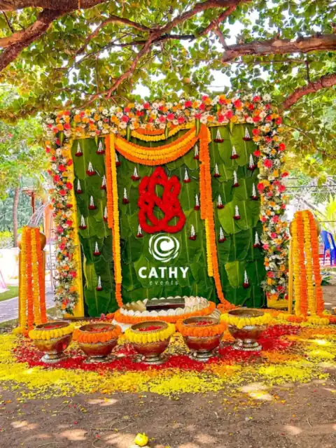 Ganesha backdrop with marigolds and brass lamps