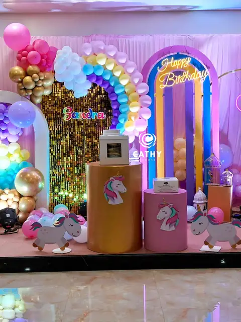 Rainbow and unicorn birthday stage with pastel balloons